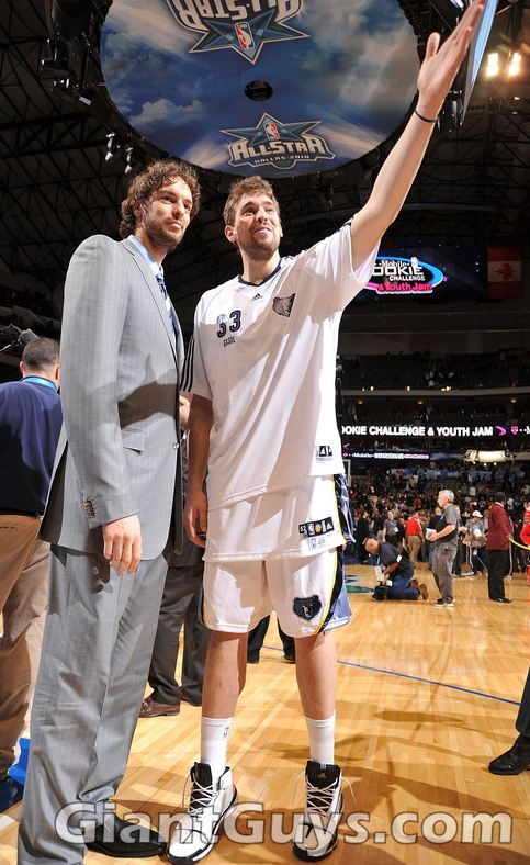 Pau Gasol in a gray suit next to his brother Marc Gasol during the NBA 2010 All Star weekend