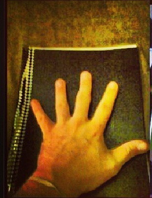 hand and notebook